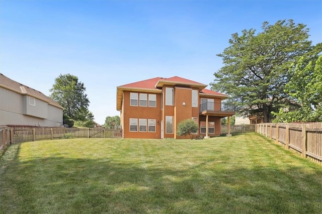 5214 NE 70th St, Kansas City, MO 64199 - back of house with a fenced backyard, stucco siding, and a balcony