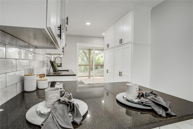 1975 Parallel Pkwy, Kansas City, KS 66104 - kitchen with white cabinetry, granite tiled floors, dark stone counters, and recessed lighting