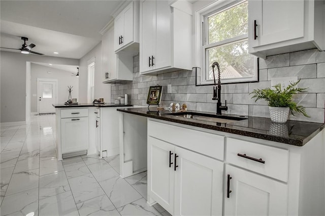 1975 Parallel Pkwy, Kansas City, KS 66104 - kitchen with a ceiling fan, recessed lighting, white cabinets, light marble finish floors, and backsplash