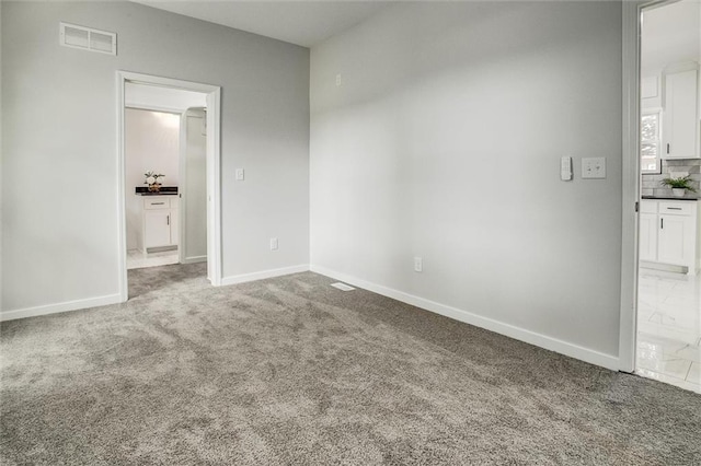 1975 Parallel Pkwy, Kansas City, KS 66104 - unfurnished bedroom featuring carpet floors and ensuite bathroom
