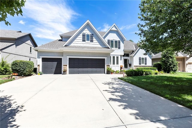 16369 S Woodstone Dr, Olathe, KS 66062 - craftsman inspired home with a front lawn, driveway, an attached garage, and a shingled roof