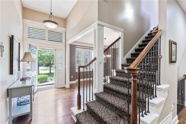 16369 S Woodstone Dr, Olathe, KS 66062 - entryway with stairway, wood finished floors, and a towering ceiling