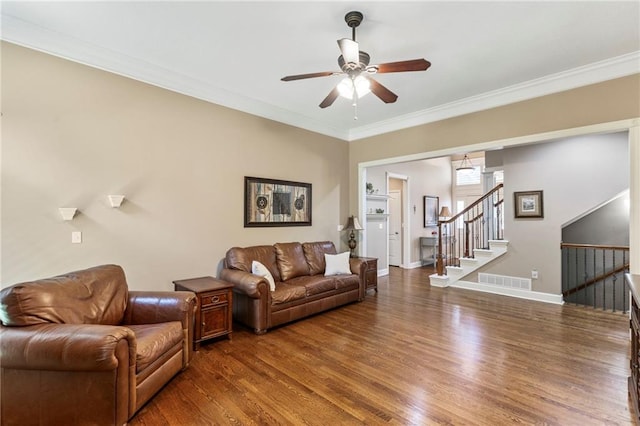 16369 S Woodstone Dr, Olathe, KS 66062 - living room featuring wood finished floors, a ceiling fan, crown molding, and stairs