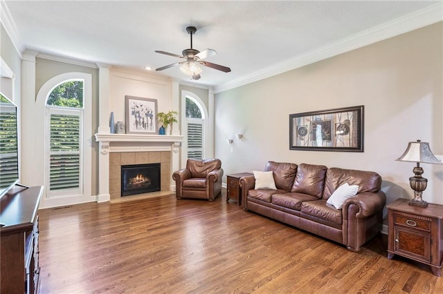 16369 S Woodstone Dr, Olathe, KS 66062 - living room featuring healthy amount of natural light, ceiling fan, wood finished floors, and ornamental molding