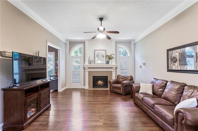 16369 S Woodstone Dr, Olathe, KS 66062 - living area with a tile fireplace, dark wood-type flooring, plenty of natural light, ceiling fan, and ornamental molding