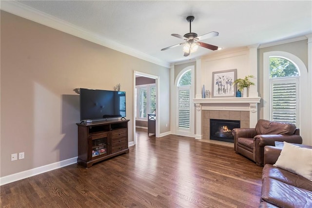 16369 S Woodstone Dr, Olathe, KS 66062 - living room featuring dark wood-type flooring, a fireplace, ornamental molding, and ceiling fan
