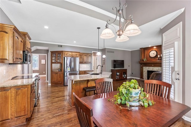 16369 S Woodstone Dr, Olathe, KS 66062 - dining room with dark wood finished floors, crown molding, a fireplace, recessed lighting, and a chandelier