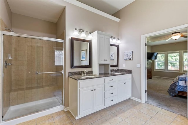 16369 S Woodstone Dr, Olathe, KS 66062 - bathroom with double vanity, tile patterned flooring, ensuite bathroom, a shower stall, and ceiling fan