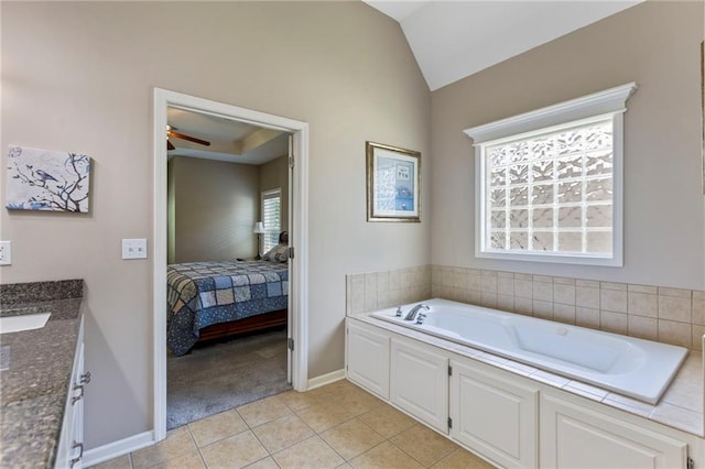 16369 S Woodstone Dr, Olathe, KS 66062 - bathroom featuring a bath, vanity, lofted ceiling, a ceiling fan, and tile patterned floors