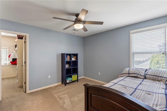 16369 S Woodstone Dr, Olathe, KS 66062 - bedroom featuring light carpet, a textured ceiling, and a ceiling fan