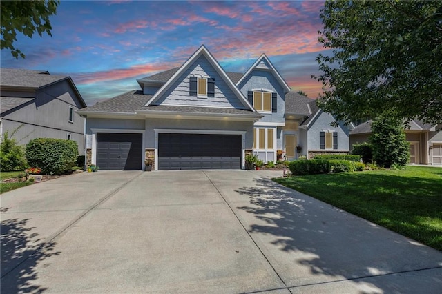 16369 S Woodstone Dr, Olathe, KS 66062 - view of front of home featuring driveway, a front yard, a garage, and a shingled roof