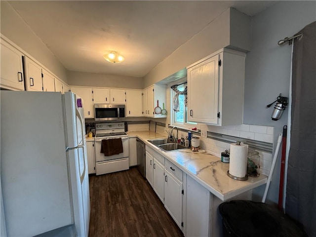 913 N Pine St, Cameron, MO 64429 - kitchen featuring stainless steel appliances, light countertops, dark wood finished floors, and white cabinetry
