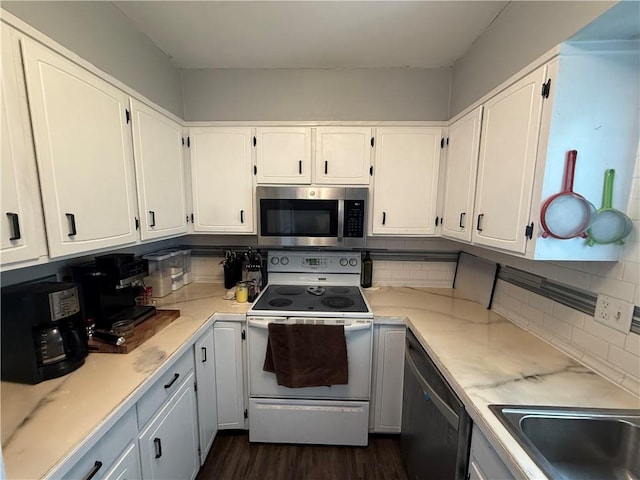 913 N Pine St, Cameron, MO 64429 - kitchen with appliances with stainless steel finishes, white cabinetry, and light countertops