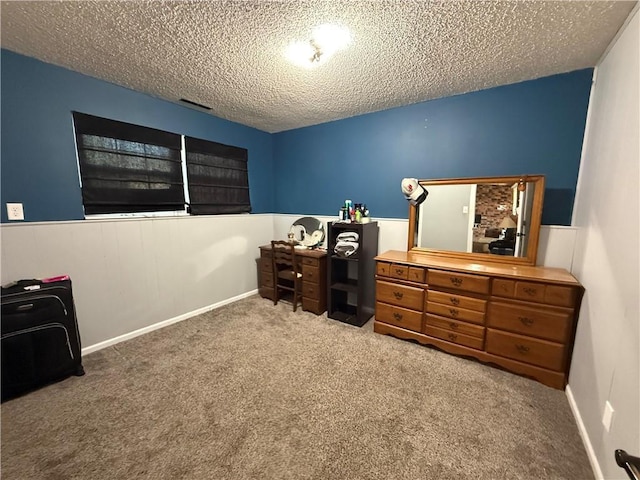 913 N Pine St, Cameron, MO 64429 - home office featuring a textured ceiling, carpet flooring, and a wainscoted wall