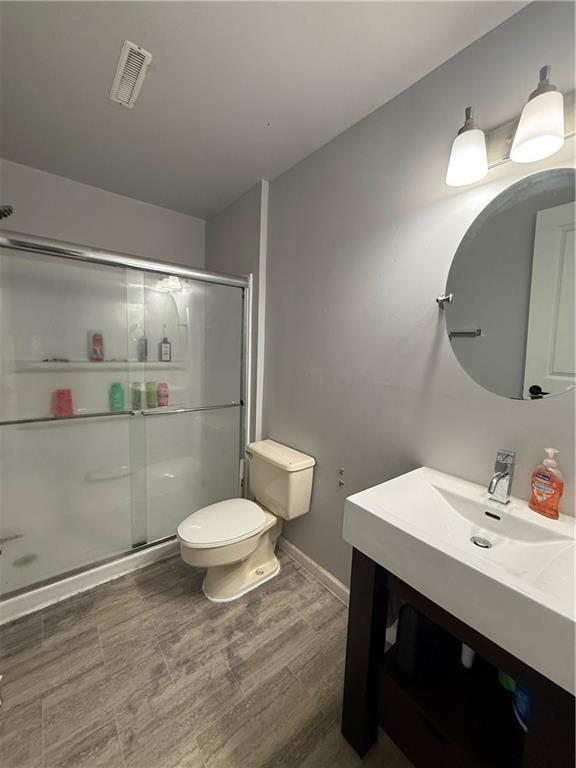 913 N Pine St, Cameron, MO 64429 - bathroom featuring vanity and a stall shower