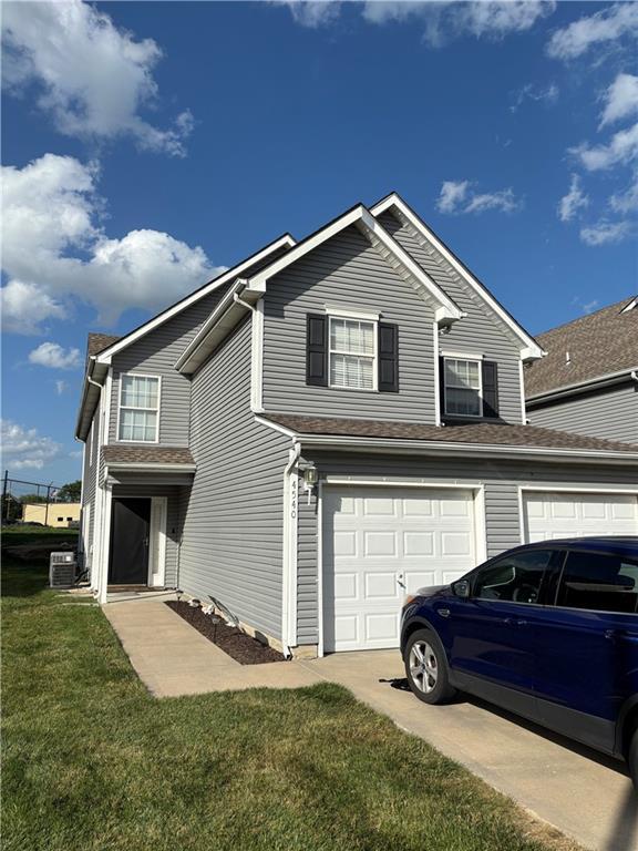 4540 NE 83rd Ter, Kansas City, MO 64119 - view of front of home featuring a garage and a front lawn