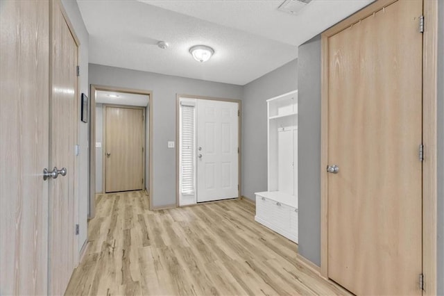 4540 NE 83rd Ter, Kansas City, MO 64119 - entrance foyer featuring light wood-style floors and a textured ceiling