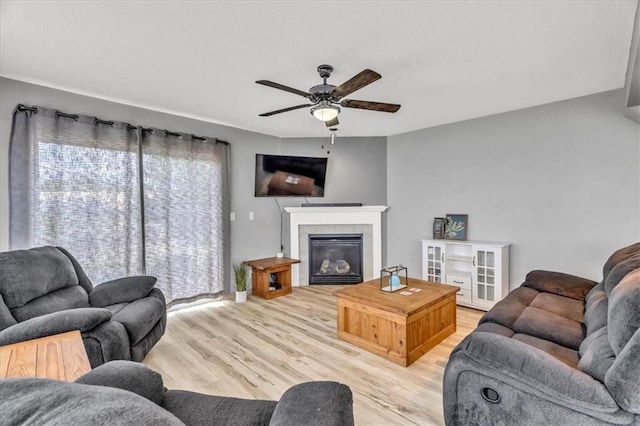 4540 NE 83rd Ter, Kansas City, MO 64119 - living room with a ceiling fan, light wood-type flooring, and a fireplace
