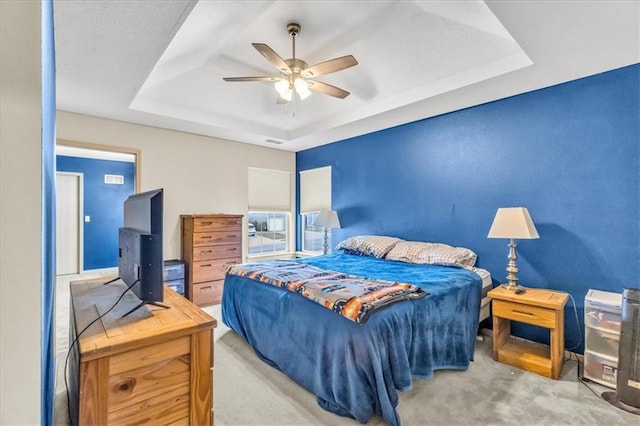 4540 NE 83rd Ter, Kansas City, MO 64119 - carpeted bedroom with a tray ceiling and ceiling fan