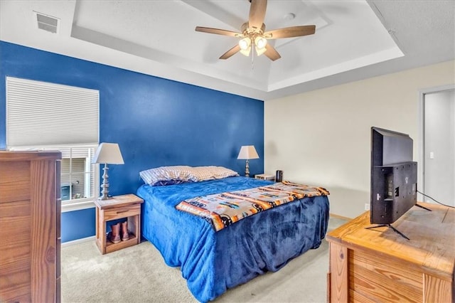 4540 NE 83rd Ter, Kansas City, MO 64119 - bedroom featuring a tray ceiling, carpet, and a ceiling fan