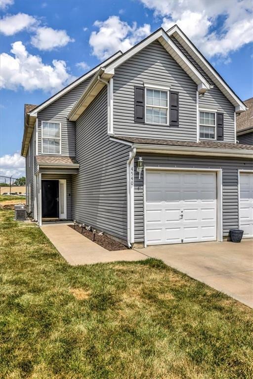 4540 NE 83rd Ter, Kansas City, MO 64119 - traditional home with a front lawn, concrete driveway, and a garage