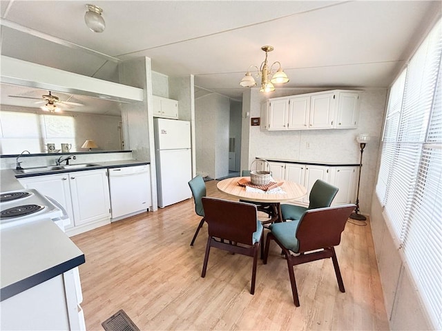 122 Fairway Dr, Mound City, KS 66056 - dining area with light wood-type flooring, a chandelier, and ceiling fan