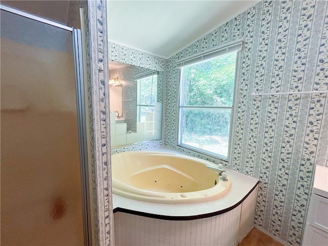 122 Fairway Dr, Mound City, KS 66056 - bathroom featuring a jetted tub, a shower stall, and wallpapered walls