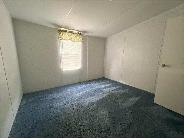 122 Fairway Dr, Mound City, KS 66056 - spare room featuring dark colored carpet