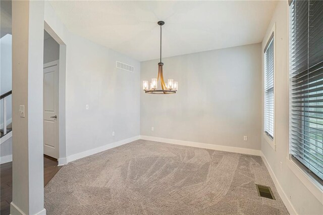 14446 Houston St, Olathe, KS 66061 - spare room featuring plenty of natural light, carpet floors, and a chandelier