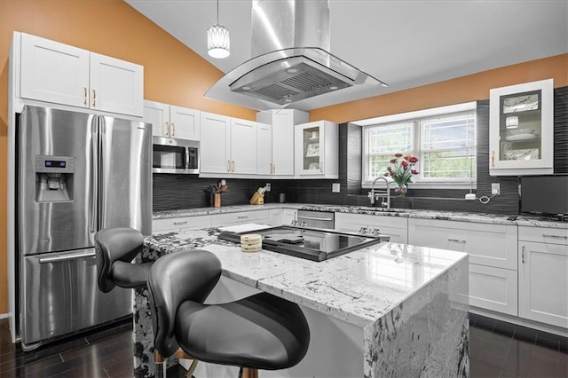 7103 E 159th St, Belton, MO 64012 - kitchen with appliances with stainless steel finishes, island range hood, decorative backsplash, glass insert cabinets, and a center island