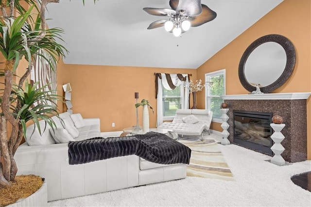7103 E 159th St, Belton, MO 64012 - living area with vaulted ceiling, a glass covered fireplace, ceiling fan, and carpet flooring