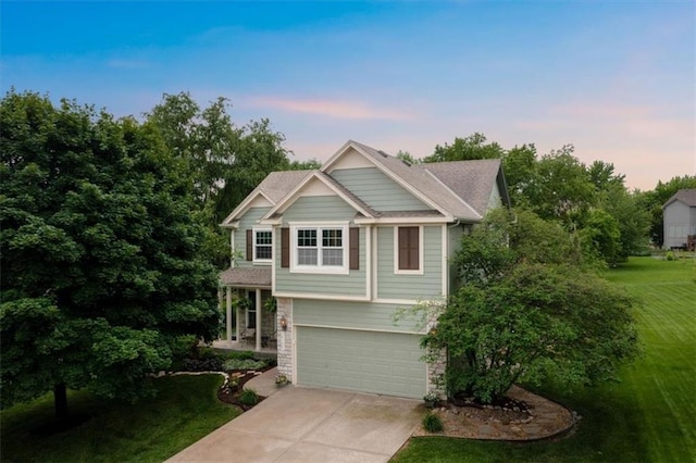 14155 W 147th Ter, Olathe, KS 66062 - view of front of house featuring concrete driveway, a front yard, an attached garage, and stone siding