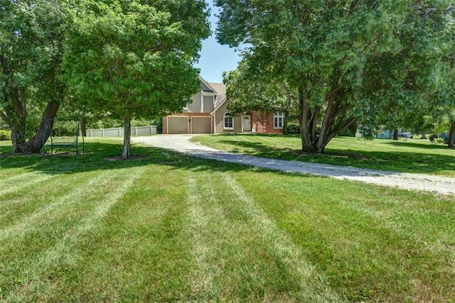 3147 N 131st St, Kansas City, KS 66109 - view of yard with driveway and a garage