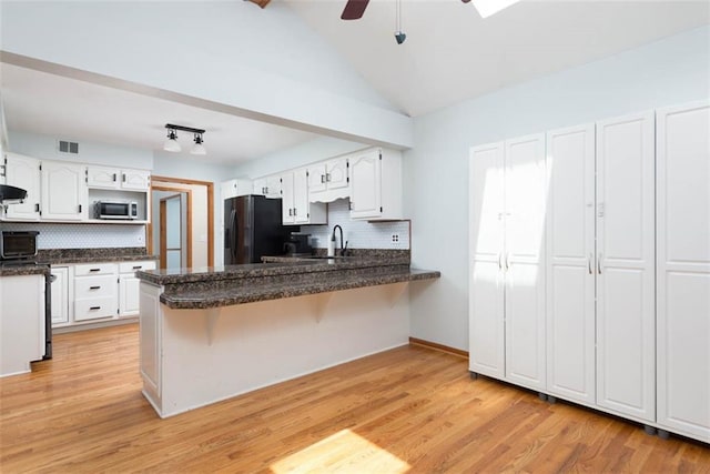 3147 N 131st St, Kansas City, KS 66109 - kitchen featuring fridge with ice dispenser, stainless steel microwave, a peninsula, backsplash, and dark countertops