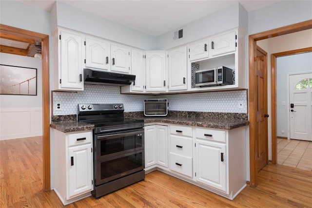 3147 N 131st St, Kansas City, KS 66109 - kitchen with range with two ovens, under cabinet range hood, stainless steel microwave, and white cabinets