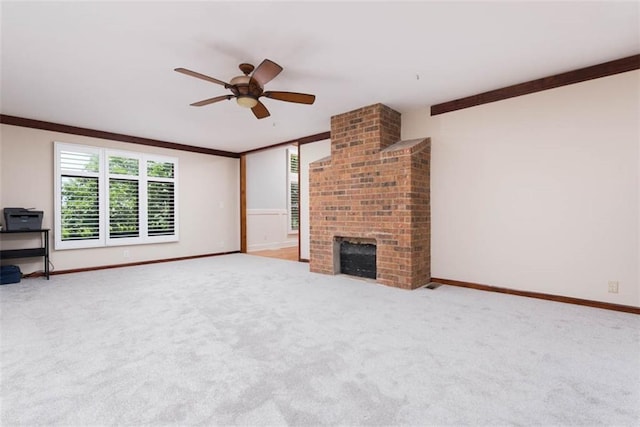 3147 N 131st St, Kansas City, KS 66109 - unfurnished living room with ceiling fan, carpet flooring, a brick fireplace, and crown molding