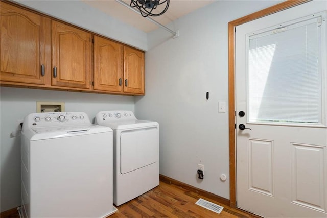 3147 N 131st St, Kansas City, KS 66109 - washroom featuring separate washer and dryer, cabinet space, and wood finished floors