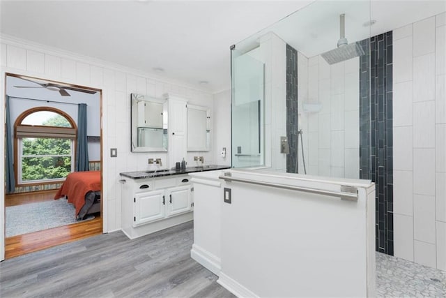 3147 N 131st St, Kansas City, KS 66109 - ensuite bathroom with ornamental molding, vanity, walk in shower, wood finished floors, and a ceiling fan