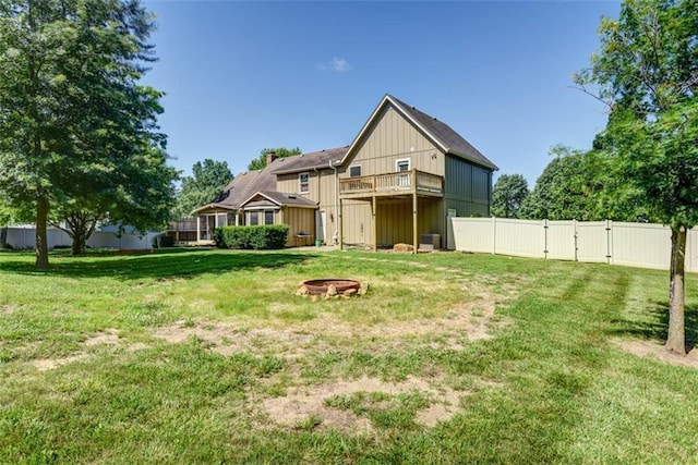 3147 N 131st St, Kansas City, KS 66109 - rear view of house with a fire pit, a gate, a balcony, and board and batten siding