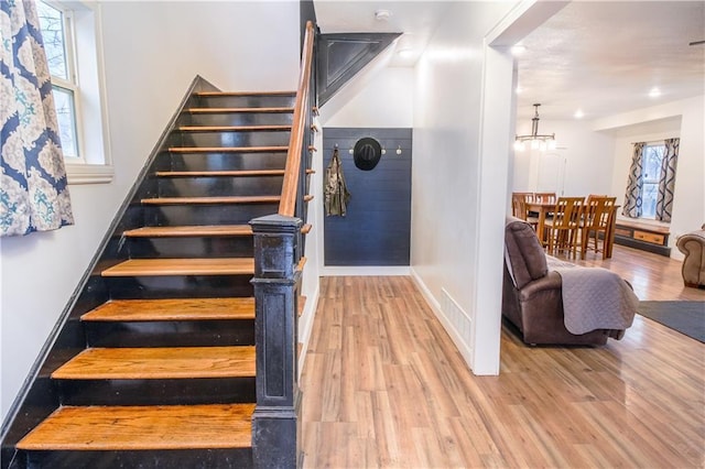 1811 Kimball Ave, Kansas City, KS 66104 - stairs featuring wood finished floors, a chandelier, and recessed lighting