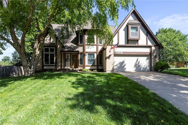 11808 W 128th St, Overland Park, KS 66213 - tudor-style house featuring concrete driveway, stucco siding, and an attached garage