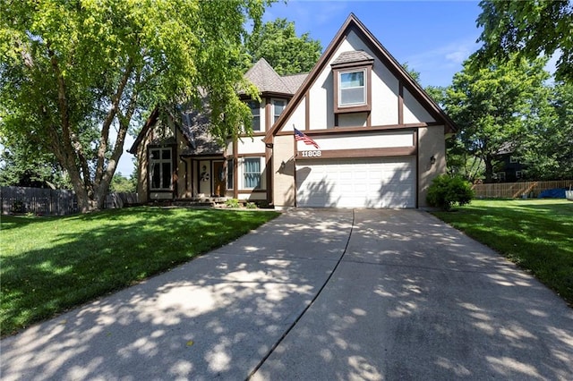 11808 W 128th St, Overland Park, KS 66213 - tudor-style house with driveway, stucco siding, and a garage
