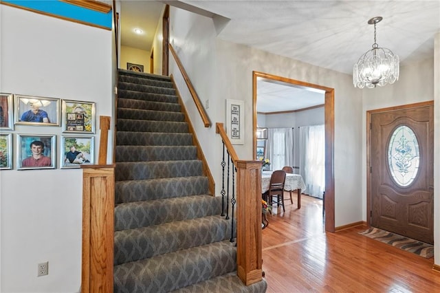 11808 W 128th St, Overland Park, KS 66213 - foyer with stairway, wood finished floors, and a chandelier