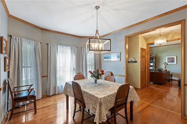 11808 W 128th St, Overland Park, KS 66213 - dining space with a chandelier, light wood-type flooring, and ornamental molding