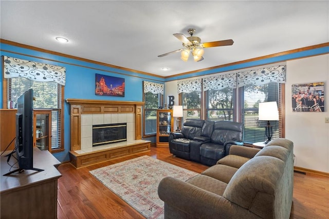 11808 W 128th St, Overland Park, KS 66213 - living area with a ceiling fan, crown molding, a tile fireplace, wood finished floors, and recessed lighting