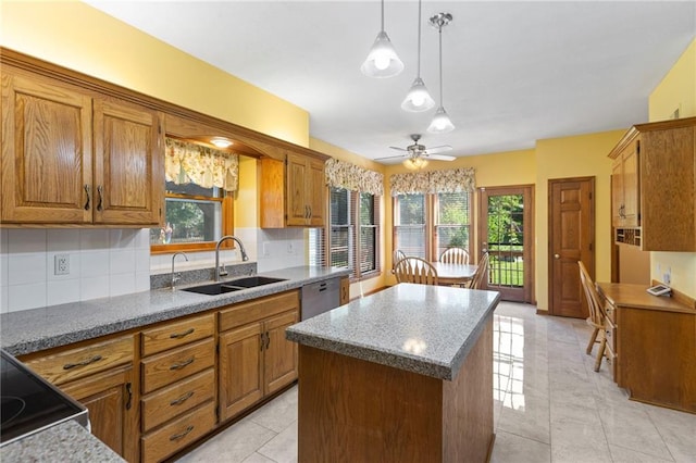 11808 W 128th St, Overland Park, KS 66213 - kitchen featuring a kitchen island, brown cabinetry, stainless steel dishwasher, ceiling fan, and healthy amount of natural light