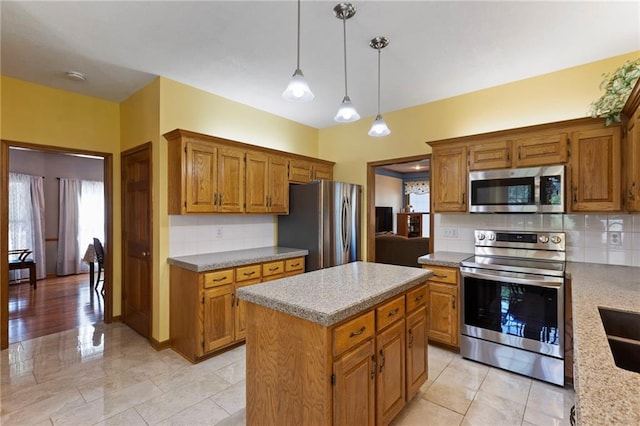 11808 W 128th St, Overland Park, KS 66213 - kitchen featuring appliances with stainless steel finishes, backsplash, brown cabinets, a center island, and hanging light fixtures
