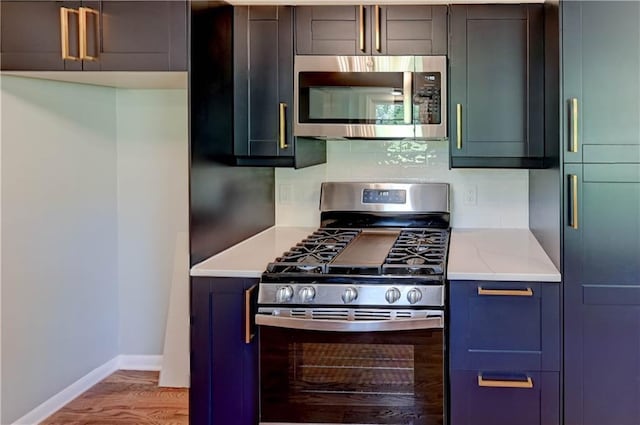 16300 E Independence Ave, Independence, MO 64050 - kitchen featuring stainless steel appliances, wood finished floors, and tasteful backsplash