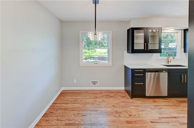 16300 E Independence Ave, Independence, MO 64050 - kitchen featuring dishwasher, light wood-style floors, plenty of natural light, and glass insert cabinets