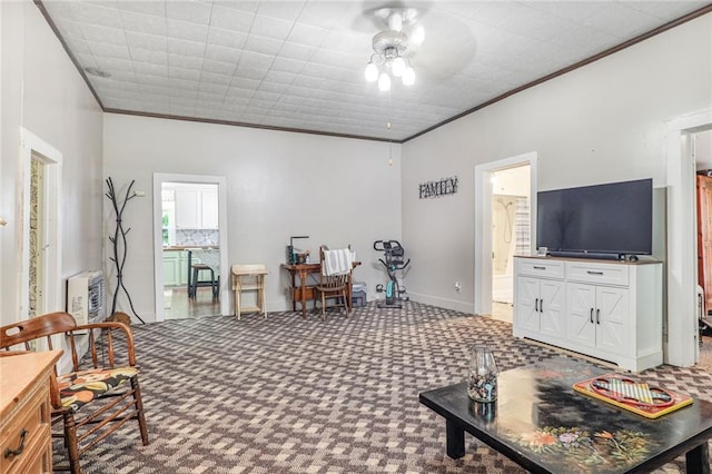 311 E Mary St, Yates Center, KS 66783 - carpeted living room featuring crown molding and ceiling fan